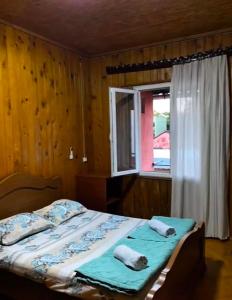a bedroom with a bed with two pillows and a window at double room in Ureki