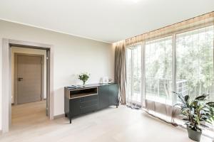an empty living room with a large window at Imanta Garden Townhouses in Riga