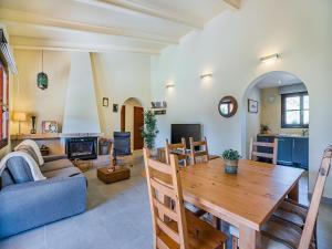 a living room with a wooden table and a couch at 3-Bed Villa with Pool, Puerto Pollença in Port de Pollensa