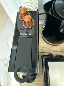 aresso machine with two cups on top of it at Anastasia B in Ofrínion