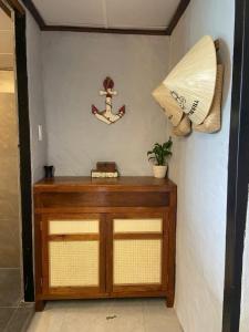 a room with a wooden cabinet with a anchor on the wall at THE NAM DU HILL resort in Nam Du +171 photos