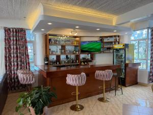 a bar with two stools in a room at Stardom Hotel in Nairobi