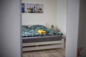 a bedroom with a bed with a yellow stuffed animal on it at H apartmán Jankov in Jankov