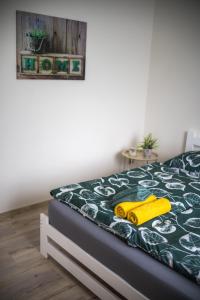a bedroom with a bed with a yellow toy car on it at H apartmán Jankov in Jankov +54 photos