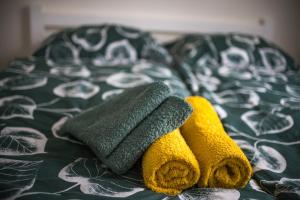 a bed with three towels on top of it at H apartmán Jankov in Jankov