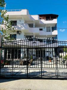 a building with a gate in front of it at Hostel Calao in Shkodër