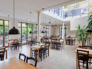 a restaurant with tables and chairs and windows at Appartement mit All inklusive Angebot und Pool in Runding