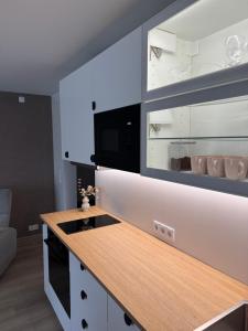 a kitchen with white cabinets and a wooden counter top at Taagepera Guest Apartment in Taagepera +4 photos