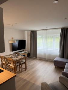 a living room with a table and a dining room at Taagepera Guest Apartment in Taagepera
