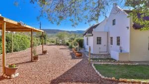 a courtyard of a white building with potted plants at Plum Tree Cottage in McGregor