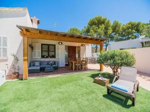 a backyard with a pergola and a table and chairs at 3-Bed Villa with Pool, Puerto Pollença in Port de Pollensa