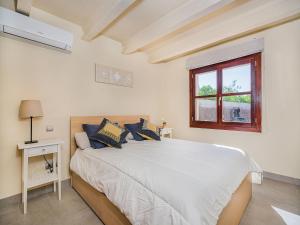a bedroom with a large white bed and a window at 3-Bed Villa with Pool, Puerto Pollença in Port de Pollensa +18 photos