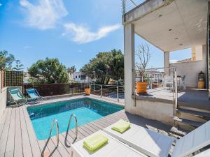 a swimming pool on a deck next to a house at Playa de Muro Chalet with Pool for 6 in Playa de Muro