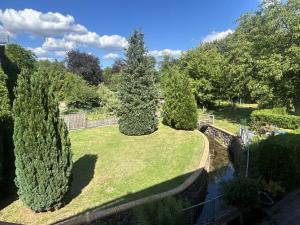 a garden with three trees and a fence at DREI SEEN HOTEL BRANDENBURG in Lindow Ratskeller in Lindow