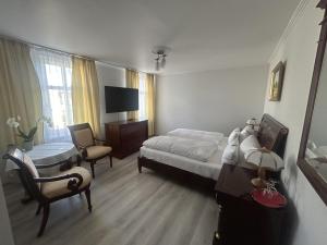 a hotel room with a bed and a chair at DREI SEEN HOTEL BRANDENBURG in Lindow Ratskeller in Lindow +4 photos