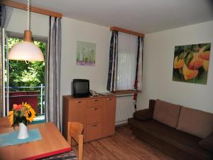 a living room with a couch and a table at Appartement mit All inklusive Angebot und Pool in Runding