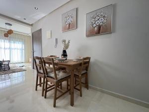 a dining room with a wooden table and chairs at Nakhla in Dar Bouazza