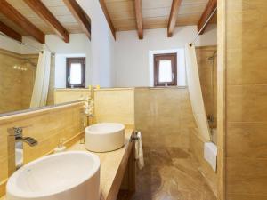 a bathroom with a sink and a mirror at Modern Rustic Country Villa with Pool in Lloseta +14 photos