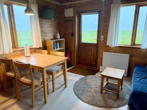 a living room with a wooden table and chairs at Egilsstaðir 1, Sjónarhóll, Urridafossvegur, Selfoss in Selfoss