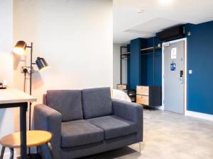 a living room with a couch and a bed at Student Only Studio in Central Loughborough in Loughborough