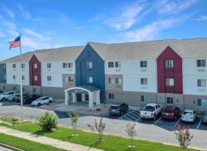 a large building with cars parked in a parking lot at Candlewood Suites Killeen - Fort Hood Area by IHG in Killeen