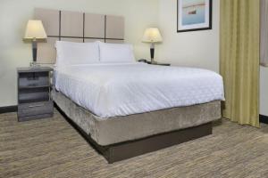 a large bed in a hotel room with two lamps at Candlewood Suites Killeen - Fort Hood Area by IHG in Killeen