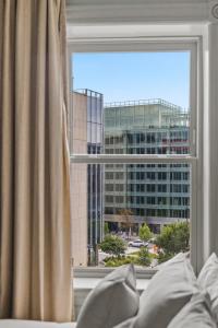 a bedroom window with a view of a building at Suite 5B at Maison Dupont a Dupont Circle Inn in Washington, D.C.