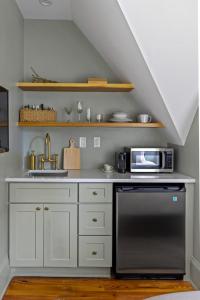 a kitchen with a sink and a microwave at Suite 5B at Maison Dupont a Dupont Circle Inn in Washington, D.C.