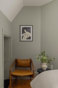 a chair in a room with a picture on the wall at Suite 5B at Maison Dupont a Dupont Circle Inn in Washington, D.C.
