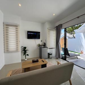 a living room with a couch and a table at Glory Moon Resort in Bophut