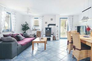 a living room with a couch and a table at Ferienhaus-Seehund in Glowe