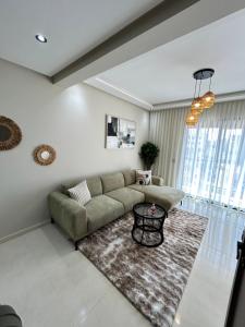 a living room with a couch and a rug at Nakhla in Dar Bouazza