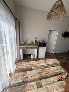 a room with a kitchen with a table and a window at Berg & Baai guesthouse in Plettenberg Bay