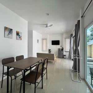 a dining room and living room with a table and chairs at Glory Moon Resort in Bophut