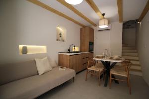 a living room with a couch and a table at Almara stone house - Authentic stone house in Vis in Vis
