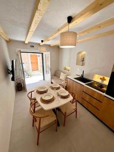 a kitchen and dining room with a table and chairs at Almara stone house - Authentic stone house in Vis in Vis