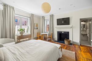 a bedroom with a bed and a fireplace at Suite 4C at Maison Dupont a Dupont Circle Inn in Washington, D.C.