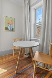 a table and chairs in a room with a window at Suite 4C at Maison Dupont a Dupont Circle Inn in Washington, D.C.