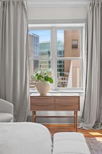 a living room with a window and a table with a plant at Suite 4C at Maison Dupont a Dupont Circle Inn in Washington, D.C. +23 photos