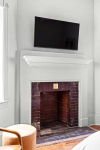 a fireplace with a flat screen tv above it at Suite 3B at Maison Dupont a Dupont Circle Inn in Washington, D.C.