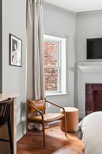 a bedroom with a bed and a chair and a window at Suite 3B at Maison Dupont a Dupont Circle Inn in Washington, D.C. +23 photos