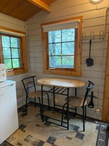 a kitchen with a table and chairs in a room at Egilsstadir 1, Skógarkot, Urridafossvegur, Selfoss in Selfoss