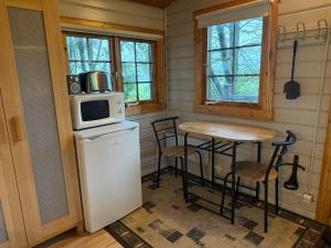 a small kitchen with a small table and a microwave at Egilsstadir 1, Skógarkot, Urridafossvegur, Selfoss in Selfoss