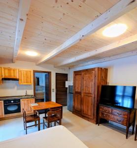 a kitchen with a table and a dining room at Residence Moulin in Aymavilles