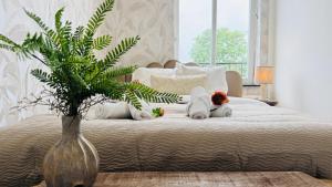 a bedroom with a large bed with two stuffed animals on it at Cooth's Prestige at the Square in Breda