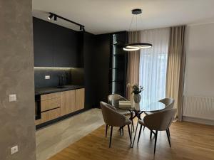 a kitchen and dining room with a table and chairs at NOVA Olimpia Residence - Free Garage in Sarajevo