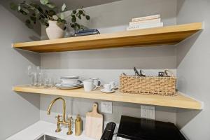 a kitchen with wooden shelves above a kitchen sink at Suite 1B at Maison Dupont a Dupont Circle Inn in Washington, D.C. +11 photos
