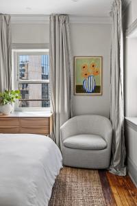 a bedroom with a chair and a bed and a window at Suite 5C at Maison Dupont a Dupont Circle Inn in Washington, D.C.