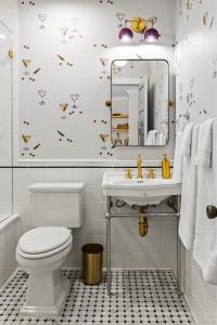 a bathroom with a toilet and a sink and a mirror at Suite 5C at Maison Dupont a Dupont Circle Inn in Washington, D.C. +26 photos