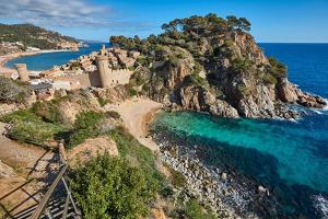 an aerial view of a beach with a castle and the ocean at Max in Tossa de Mar